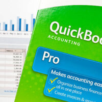 San Marcos, USA - July 5, 2011: QuickBooks box on graphs. Quickbooks is an accounting software program created by INTUIT corporation. It is the most popular accounting software program for small business with over 90% market share.